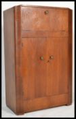 An art deco 1930's stained oak metamorphic cocktail cabinet. The cabinet having a metamorphic action