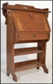 A late 19th century oak arts & crafts student bureau in the manner of Liberty & Co. The fall front