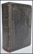 A 19th century leather bound bible with embossed details to the covers printed by George Eyre and