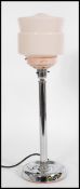 A vintage retro 20th century Art Deco table lamp raised on a circular base with tubular column and