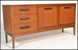 A vintage retro 20th century teak wood sideboard raised on tapered supports having a fall front