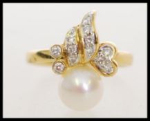 A hallmarked 18ct gold cultured pearl and diamond pendant ring having decorative articulating head