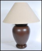 A contemporary 20th century French FDC ceramic large table lamp raised on a bulbous circular foot