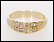 A 20th century 9ct gold and diamond ring with diamonds set in a domed design. Marked 9ct tests 9ct