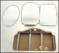 A collection of mid 20th century frameless wall mirrors on wooden backs, shaped with bevelled