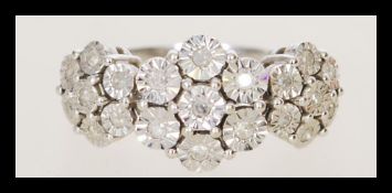 A 20th century hallmarked 9ct white gold and diamond  ring having a triple floral head cluster