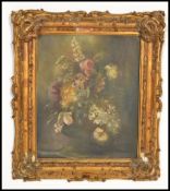 A 19th century oil painting still life depicting floral sprays held within an ornate gilt frame.