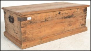 A 19th Century pine blanket box, hinged top with iron lock to front, iron handles to the side.