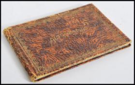 A 20th century autograph book, with a textured cover and gilt lettering, including autographs from