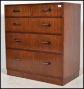 A 20th century mahogany set of two over three drawers having Art Deco geometric design handles, on a