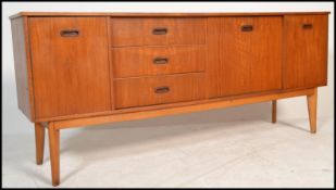 A vintage retro 20th century teak wood sideboard raised on tapered supports with bank of drawers,