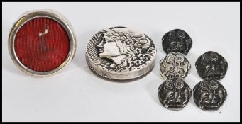 An early 20th century Art Nouveau silver hallmarked pill box with an embossed female figure to the