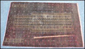 A early to mid 20th Century Islamic Middle Eastern prayer rug / mat on red ground, the mat decorated