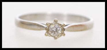 A hallmarked 18ct white gold diamond solitaire ring. Diamond approx 10pts. Weight 2g. Size N.5.