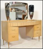 A vintage retro 20th century light wood veneer dressing table having a triptych mirror back. The