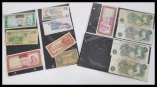 A collection of vintage monetary notes from around the world to include War time notes,  £1 notes,