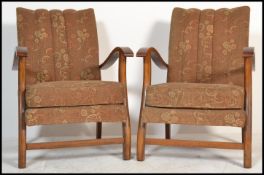 A pair of 1920's bentwood fireside armchairs being overstuffed and moquette upholstered with
