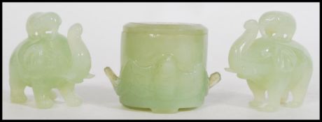 A group of three 20th century Chinese jade items to include a lidded pot and a pair of elephants
