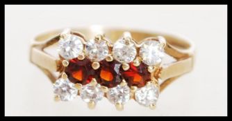 A hallmarked 9ct gold red and CZ stone ring being hallmarked for Birmingham 1983 makers SGW.