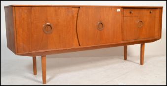 A mid century / 1960's period Danish inspired sideboard credenza. The sideboard with a cupboards and