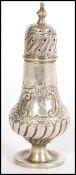 A 19th century hallmarked silver cruet / pepper pot, raised on a round base with embossed floral