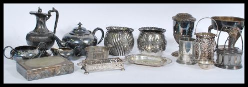 A selection of silver plate wares to include a pair of bulbous vases with floral engraving and