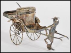 A 20th century Chinese silver condiment in the form a gondola having basket and spoon to seat with