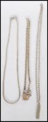 A selection of silver chains and pendants to include a London hallmarked pendant chain and a