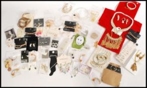 A collection of unused costume dress jewellery to include necklaces, bangles, bracelets, rings,