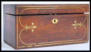 A 19th century rose wood tea caddy with brass inlay to the top and sides, having a shaped scutcheon,