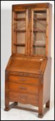 An early 20th Century Oak bureau bookcase, glazed doors over fall front with fully appointed