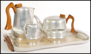 A 20th century Picquot Ware tea service to include tea and coffee pot with wooden handles, a twin