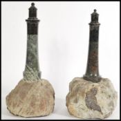 A pair of serpentine stone mantle piece ornaments of light houses, on unpolished stone. Highest