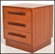 A retro 20th Century G Plan bedside chest of three drawers in the Fresco pattern raised on a