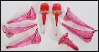 A set of 5 ruby / cranberry glass epergne flower trumpets in the form of tulips. Each of tapering