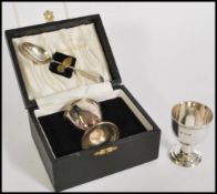 A silver hallmarked eggcup and spoon complete in fitted case along with another silver hallmarked