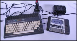 A retro 20th Century Commodore Plus 4 264 Series, unboxed, including accessories, cables, Data