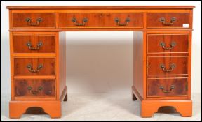An antique Georgian style mahogany yew wood twin pedestal office desk having pedestals, each with