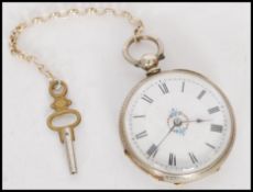 An early 20th century silver continental ladies fob watch with enamel dial. Rococo chasing to the