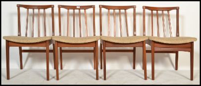 A set of four retro 20th Century teak Danish inspired dining chairs. Raised on tapering supports