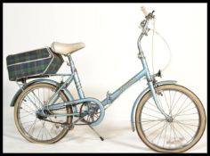 A retro 1980's ladies folding bicycle by Hercules in the original colourway with saddle and
