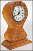 A late 19th Century / early 20th Century satinwood Art Nouveau inlaid mantel clock, decorated with
