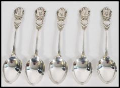A set of 5 unusual silver hallmarked teaspoons with the handles bearing crest of soldier and