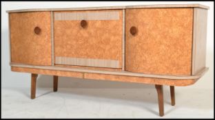 A 1960's Italian melamine / formica sideboard having laquered finish raised on angled legs with a