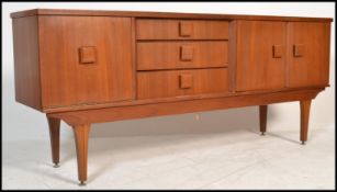A vintage retro 20th century teak wood sideboard raised on tapered legs with shaped square handles