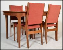 A retro 20th Century G-Plan teak large extending dining table with extending flip over leaf centre