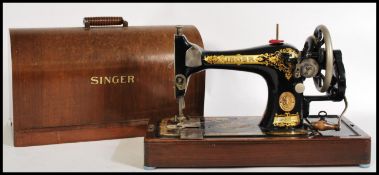 A vintage early 20th century Signer sewing machine having an ebonised body with gilt detailing.