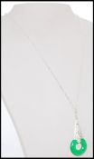A stamped 925 silver pendant necklace with a Art Deco style pendant with inset white stones and a