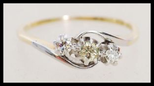 An 18ct gold ring set with three diamonds of approximately 20 points. Marks worn, tests 18ct gold.