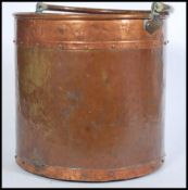 A 19th century Victorian brass and copper fireside bucket with swing handle. Measures 38cm-high